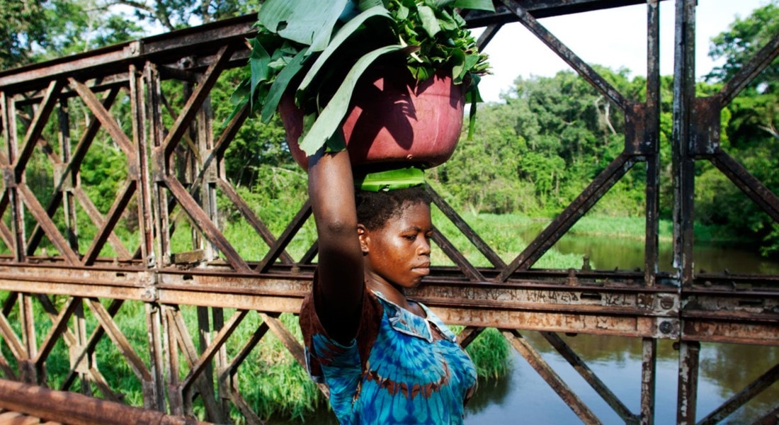 Girl walking on a bridge over the Ebola River