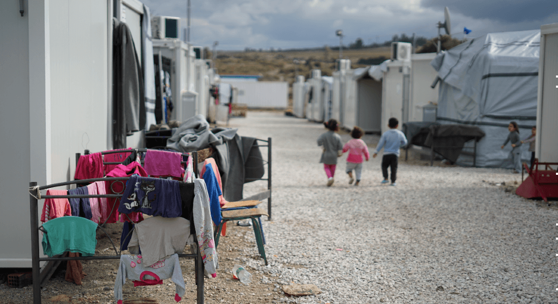 Children walking in Syrian refugee camp in the outskirts of Athens. 